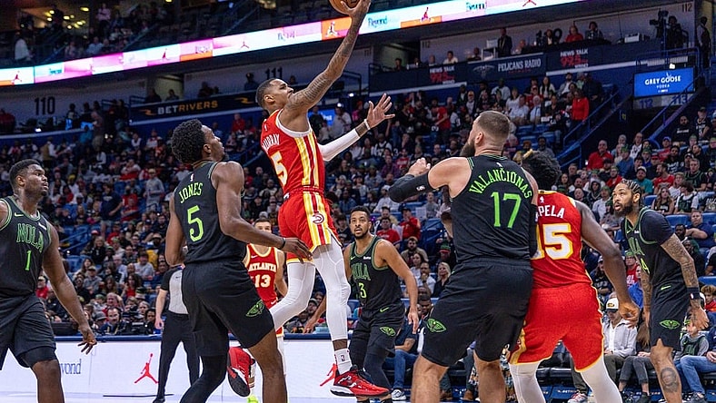 Nov 4, 2023; New Orleans, Louisiana, USA;  Atlanta Hawks guard Dejounte Murray (5) drives to the basket against New Orleans Pelicans forward Herbert Jones (5) during the first half at Smoothie King Center. Mandatory Credit: Stephen Lew-USA TODAY Sports
