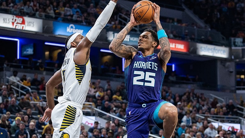 Nov 4, 2023; Indianapolis, Indiana, USA; Charlotte Hornets forward P.J. Washington (25) shoots the ball whileIndiana Pacers guard Buddy Hield (7)  defends in the first half at Gainbridge Fieldhouse. Mandatory Credit: Trevor Ruszkowski-USA TODAY Sports