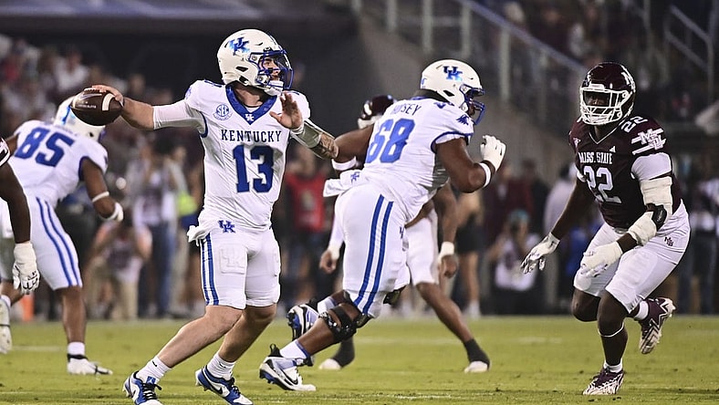 Nov 4, 2023; Starkville, Mississippi, USA; Kentucky Wildcats quarterback Devin Leary (13) makes a pass against the Mississippi State Bulldogs during the first quarter at Davis Wade Stadium at Scott Field. Mandatory Credit: Matt Bush-USA TODAY Sports