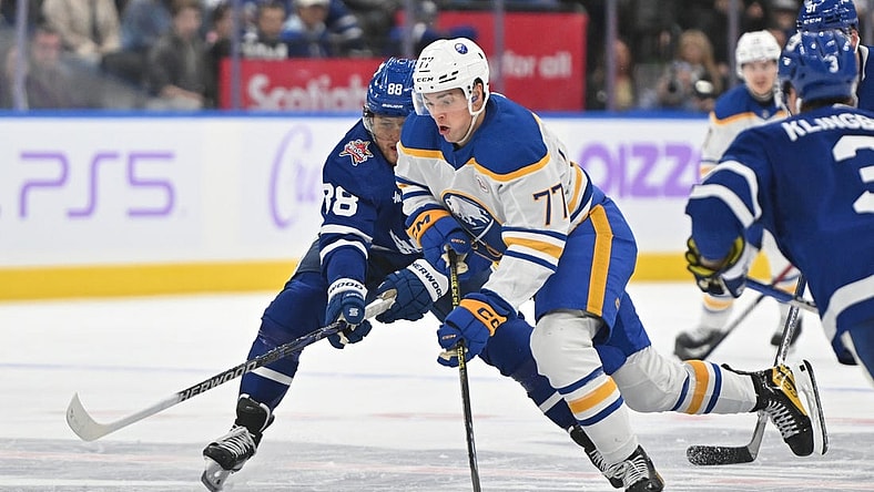 Nov 4, 2023; Toronto, Ontario, CAN;  lBuffalo Sabres forward JJ Peterka (77) skates with the puck past Toronto Maple Leafs forward William Nylander (88) in the second period at Scotiabank Arena. Mandatory Credit: Dan Hamilton-USA TODAY Sports