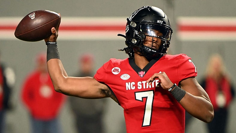 Nov 4, 2023; Raleigh, North Carolina, USA; North Carolina State Wolfpack quarterback MJ Morris (7) throws a pass during the first half against the Miami Hurricanes at Carter-Finley Stadium. Mandatory Credit: Rob Kinnan-USA TODAY Sports