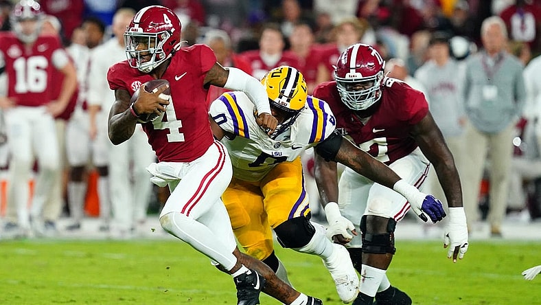 Nov 4, 2023; Tuscaloosa, Alabama, USA; Alabama Crimson Tide quarterback Jalen Milroe (4) scrambles up the field against the LSU Tigers during the second quarter at Bryant-Denny Stadium. Mandatory Credit: John David Mercer-USA TODAY Sports