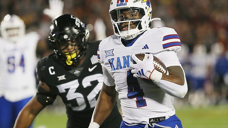 Kansas Jayhawks running back Devin Neal (4) runs for a touchdown against Iowa State during the first quarter at Jack Trice Stadium on Saturday, Nov. 4, 2023, in Ames, Iowa.