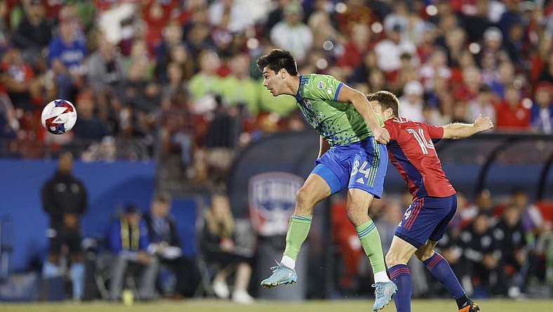 Nov 4, 2023; Frisco, Texas, USA; Seattle Sounders midfielder Josh Atencio (84) heads the ball against FC Dallas midfielder Asier Illarramendi (14) during the first half of game two in a round one match of the 2023 MLS Cup Playoffs at Toyota Stadium. Mandatory Credit: Andrew Dieb-USA TODAY Sports