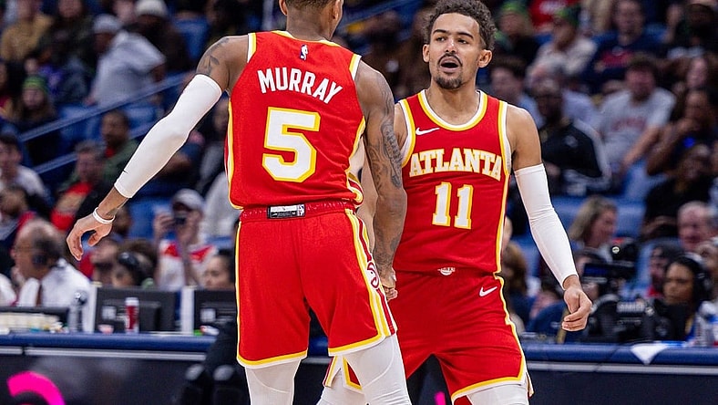 Nov 4, 2023; New Orleans, Louisiana, USA;  Atlanta Hawks guard Trae Young (11) slaps hands with guard Dejounte Murray (5) after he makes a basket against the New Orleans Pelicans during the second half at Smoothie King Center. Mandatory Credit: Stephen Lew-USA TODAY Sports