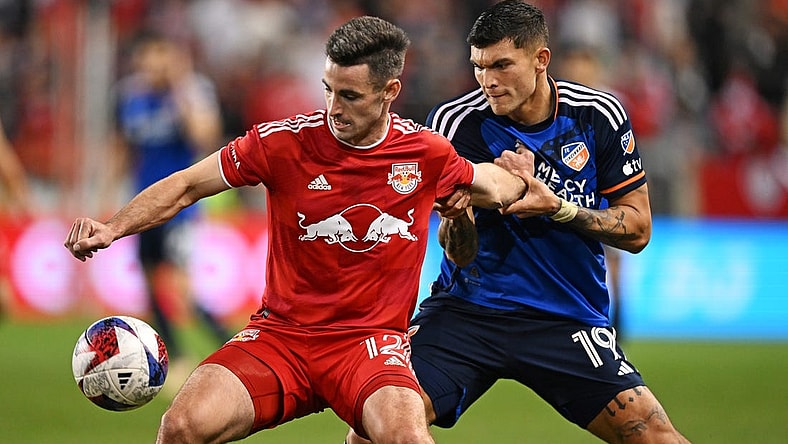 Nov 4, 2023; Harrison, NJ, USA; New York Red Bulls defender Dylan Nealis (12) and FC Cincinnati forward Brandon V zquez (19) battle for the ball during the second half of game two in a round one match of the 2023 MLS Cup Playoffs at Red Bull Arena. Mandatory Credit: Mark Smith-USA TODAY Sports