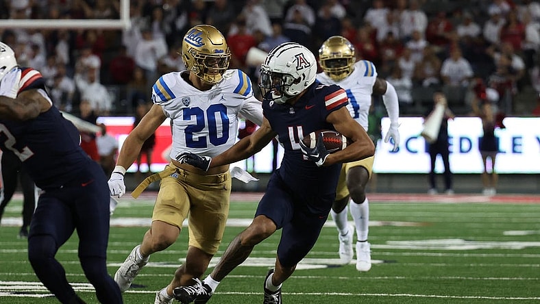 Nov 4, 2023; Tucson, Arizona, USA; Arizona Wildcats wide receiver Tetairoa McMillan #4 makes a catch for a first down against UCLA Bruins linebacker Kain Medrano #20 during the first half at Arizona Stadium. Mandatory Credit: Zachary BonDurant-USA TODAY Sports
