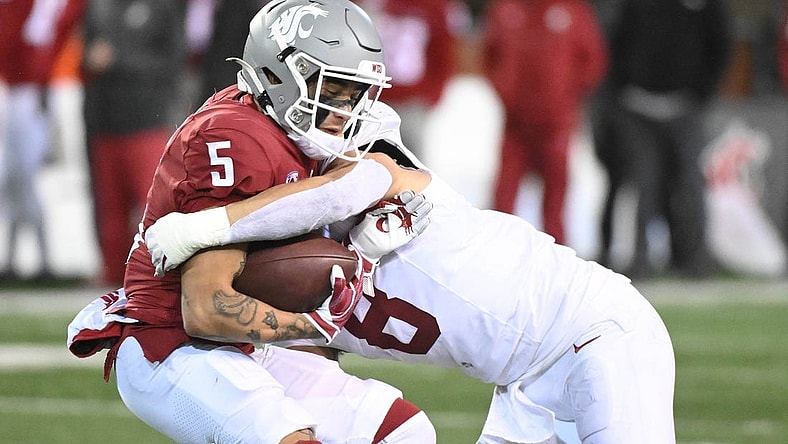 Nov 4, 2023; Pullman, Washington, USA; Washington State Cougars wide receiver Lincoln Victor (5) is stopped alert short gain by Stanford Cardinal linebacker Tristan Sinclair (8) in the second half at Gesa Field at Martin Stadium. Stanford won 10-7. Mandatory Credit: James Snook-USA TODAY Sports