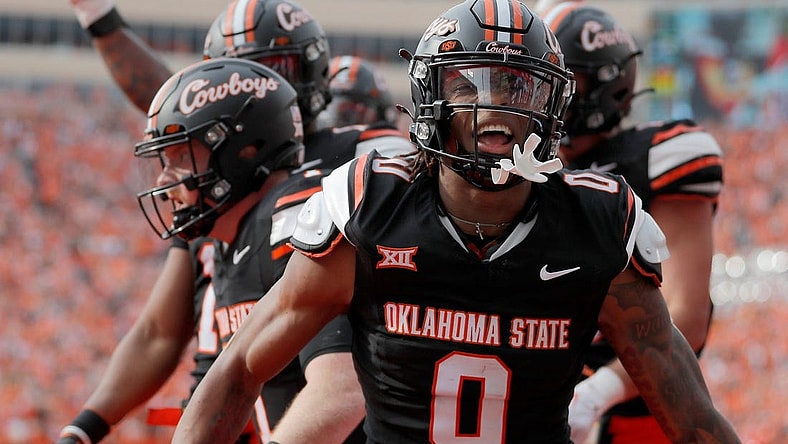 Oklahoma State's Ollie Gordon II (0) celebrates a Alan Bowman (7) touchdown in the first half during a Bedlam college football game between the Oklahoma State University Cowboys (OSU) and the University of Oklahoma Sooners (OU) at Boone Pickens Stadium in Stillwater, Okla., Saturday, Nov. 4, 2023.