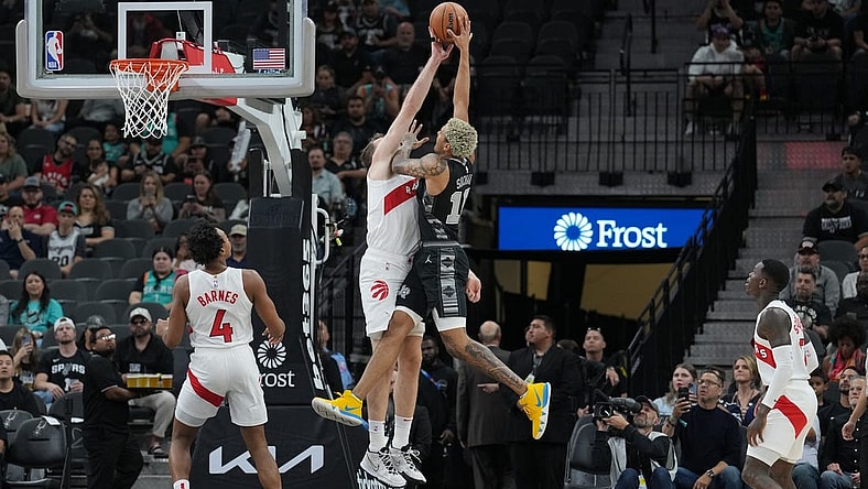 Nov 5, 2023; San Antonio, Texas, USA;  Toronto Raptors center Jakob Poeltl (19) blocks a shot by San Antonio Spurs forward Jeremy Sochan (10) in the first half at the Frost Bank Center. Mandatory Credit: Daniel Dunn-USA TODAY Sports