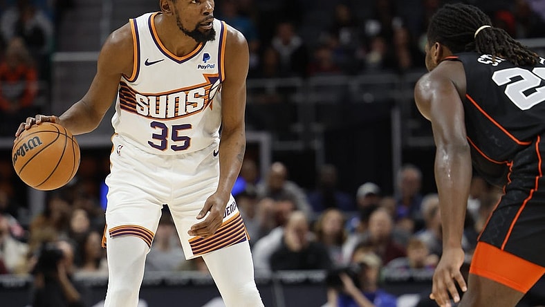 Nov 5, 2023; Detroit, Michigan, USA;  Phoenix Suns forward Kevin Durant (35) dribbles defended by Detroit Pistons center Isaiah Stewart (28) in the first half at Little Caesars Arena. Mandatory Credit: Rick Osentoski-USA TODAY Sports