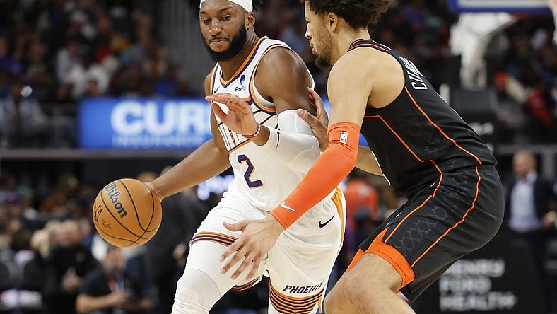 Nov 5, 2023; Detroit, Michigan, USA;  Phoenix Suns forward Josh Okogie (2) dribbles defended by Detroit Pistons guard Cade Cunningham (2) in the first half at Little Caesars Arena. Mandatory Credit: Rick Osentoski-USA TODAY Sports