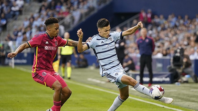 Nov 5, 2023; Kansas City, KS, USA; Sporting Kansas City forward Daniel Salloi (20) plays the ball defended by St. Louis City SC defender Akil Watts (20) in the first half of game two in a round one match of the 2023 MLS Cup Playoffs at Children's Mercy Park. Mandatory Credit: Jay Biggerstaff-USA TODAY Sports