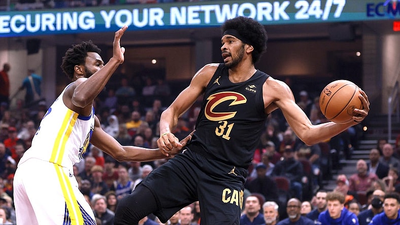 Nov 5, 2023; Cleveland, Ohio, USA; Cleveland Cavaliers center Jarett Allen (31) saves the ball from going out of bounds while defended by Golden State Warriors forward Andrew Wiggins (22) in the first quarter at Rocket Mortgage FieldHouse. Mandatory Credit: Aaron Josefczyk-USA TODAY Sports