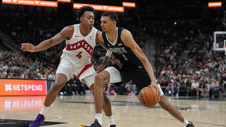 Nov 5, 2023; San Antonio, Texas, USA;  San Antonio Spurs center Victor Wembanyama (1) dribbles against Toronto Raptors forward Scottie Barnes (4) in the second half at the Frost Bank Center. Mandatory Credit: Daniel Dunn-USA TODAY Sports