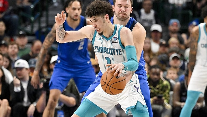 Nov 5, 2023; Dallas, Texas, USA; Dallas Mavericks guard Luka Doncic (77) attempts to knock the ball away from Charlotte Hornets guard LaMelo Ball (1) during the second quarter at the American Airlines Center. Mandatory Credit: Jerome Miron-USA TODAY Sports