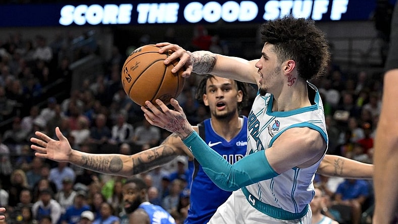 Nov 5, 2023; Dallas, Texas, USA; Charlotte Hornets guard LaMelo Ball (1) passes the ball past Dallas Mavericks center Dereck Lively II (2) during the second half at the American Airlines Center. Mandatory Credit: Jerome Miron-USA TODAY Sports