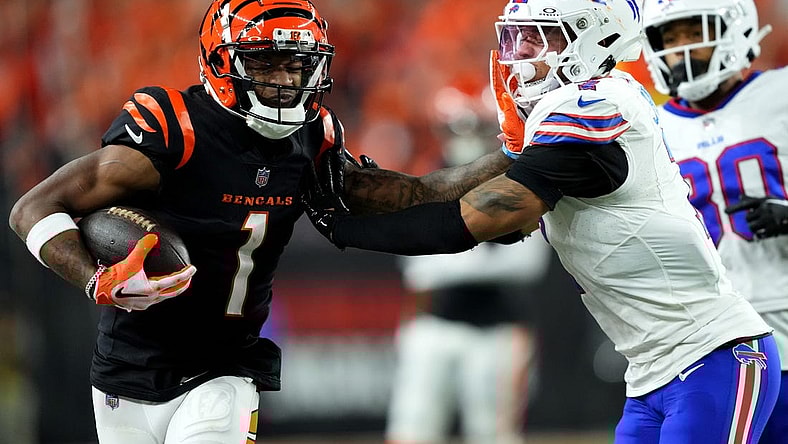 Cincinnati Bengals wide receiver Ja'Marr Chase (1) stiff arms Buffalo Bills cornerback Taron Johnson (7) after a catch in the fourth quarter during a Week 9 NFL football game between the Buffalo Bills and the Cincinnati Bengals, Sunday, Nov. 5, 2023, at Paycor Stadium in Cincinnati.