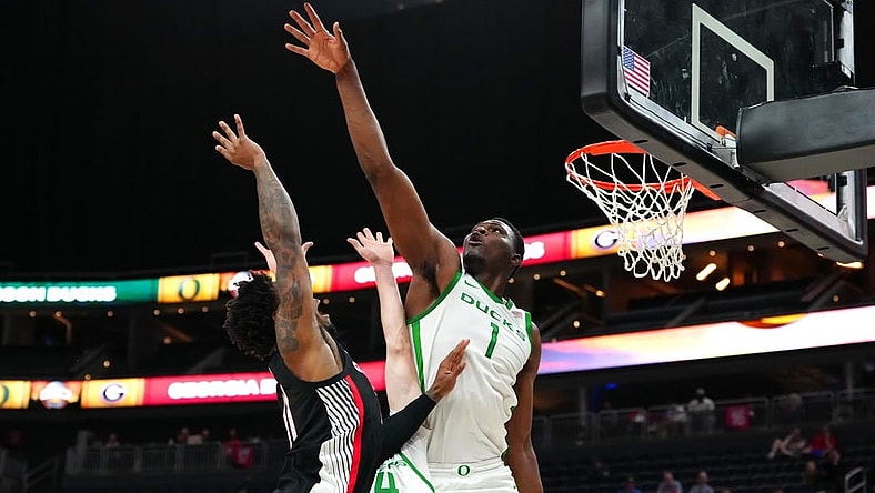 Nov 6, 2023; Las Vegas, Nevada, USA; Oregon Ducks center N'Faly Dante (1) defends against a shot by Georgia Bulldogs guard Justin Hill (11) during the second half at T-Mobile Arena. Mandatory Credit: Stephen R. Sylvanie-USA TODAY Sports