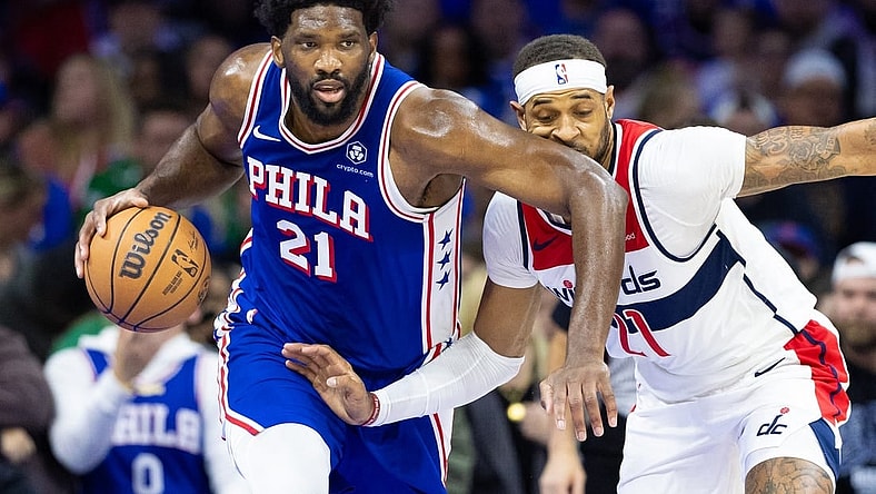 Nov 6, 2023; Philadelphia, Pennsylvania, USA; Philadelphia 76ers center Joel Embiid (21) collides with Washington Wizards forward Daniel Gafford (21) while bringing the ball up court during the first quarter at Wells Fargo Center. Mandatory Credit: Bill Streicher-USA TODAY Sports