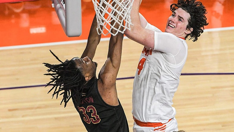 Clemson junior forward Ian Schieffelin (4) scores near Winthrop forward Chase Clayton (33) during the first half at Littlejohn Coliseum in Clemson, S.C. Monday, November 6, 2023.