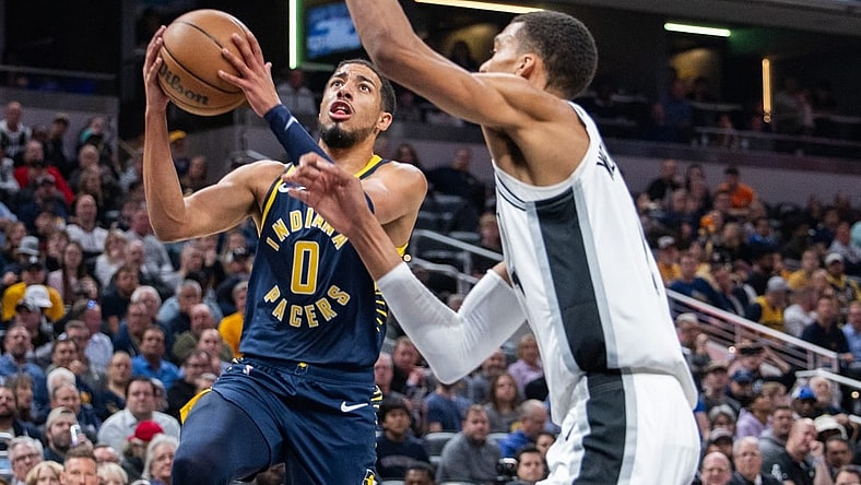 Nov 6, 2023; Indianapolis, Indiana, USA; Indiana Pacers guard Tyrese Haliburton (0)  shoots the ball while San Antonio Spurs center Victor Wembanyama (1) defends in the first half at Gainbridge Fieldhouse. Mandatory Credit: Trevor Ruszkowski-USA TODAY Sports