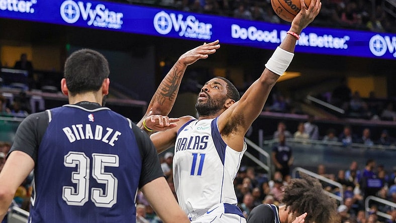 Nov 6, 2023; Orlando, Florida, USA; Dallas Mavericks guard Kyrie Irving (11) drives to the basket against Orlando Magic center Goga Bitadze (35) during the first quarter at Amway Center. Mandatory Credit: Mike Watters-USA TODAY Sports