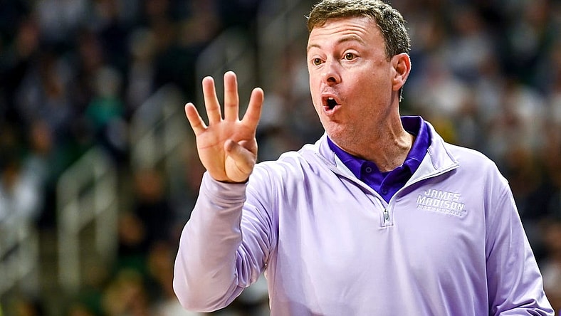 James Madison's head coach Mark Byington talks to a referee during the first half in the game against Michigan State on Monday, Nov. 6, 2023, in East Lansing.