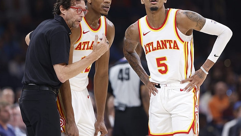 Nov 6, 2023; Oklahoma City, Oklahoma, USA; Atlanta Hawks head coach Quin Snyder talks with Atlanta Hawks forward De'Andre Hunter (12) and guard Dejounte Murray (5) during a break in play against the Oklahoma City Thunder in the second quarter at Paycom Center. Mandatory Credit: Alonzo Adams-USA TODAY Sports