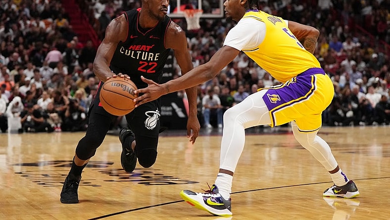 Nov 6, 2023; Miami, Florida, USA; Miami Heat forward Jimmy Butler (22) drives the ball around Los Angeles Lakers forward Cam Reddish (5) during the first half at Kaseya Center. Mandatory Credit: Jasen Vinlove-USA TODAY Sports