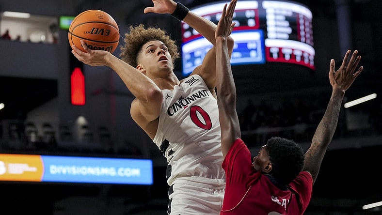 Nov 6, 2023; Cincinnati, Ohio, USA;  Cincinnati Bearcats guard Dan Skillings Jr. (0) drives to the basket against Illinois-Chicago Flames guard Steven Clay (2) in the first half at Fifth Third Arena. Mandatory Credit: Aaron Doster-USA TODAY Sports