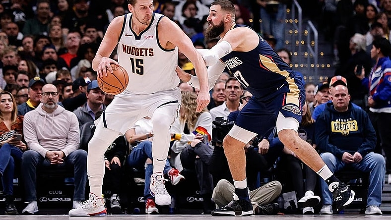 Nov 6, 2023; Denver, Colorado, USA; Denver Nuggets center Nikola Jokic (15) controls the ball as New Orleans Pelicans center Jonas Valanciunas (17) guards in the second quarter at Ball Arena. Mandatory Credit: Isaiah J. Downing-USA TODAY Sports