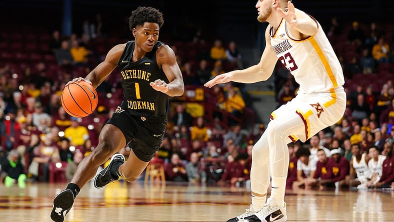 Nov 6, 2023; Minneapolis, Minnesota, USA; Bethune-Cookman Wildcats guard Zion Harmon (1) dribbles around Minnesota Golden Gophers forward Parker Fox (23) during the second half at Williams Arena. Mandatory Credit: Matt Krohn-USA TODAY Sports