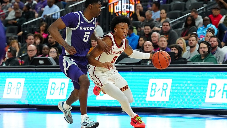 Nov 6, 2023; Las Vegas, Nevada, USA; USC Trojans guard Boogie Ellis (5) dribbles against Kansas State Wildcats guard Cam Carter (5) during the first half at T-Mobile Arena. Mandatory Credit: Stephen R. Sylvanie-USA TODAY Sports