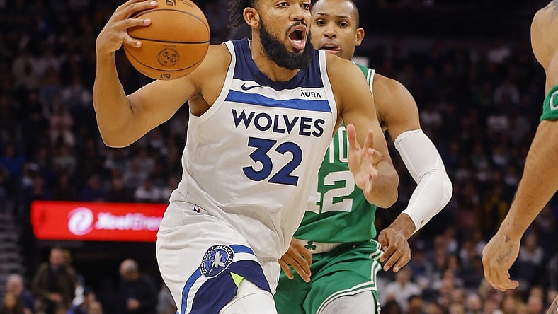 Nov 6, 2023; Minneapolis, Minnesota, USA; Minnesota Timberwolves forward Karl-Anthony Towns (32) drives to the basket past Boston Celtics center Al Horford (42) in the fourth quarter at Target Center. Mandatory Credit: Bruce Kluckhohn-USA TODAY Sports