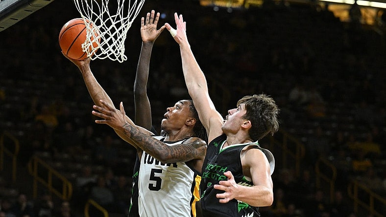 Nov 7, 2023; Iowa City, Iowa, USA; Iowa Hawkeyes guard Dasonte Bowen (5) drives against North Dakota Fighting Hawks forward Amar Kuljuhovic (3) during the first half at Carver-Hawkeye Arena. Mandatory Credit: Jeffrey Becker-USA TODAY Sports