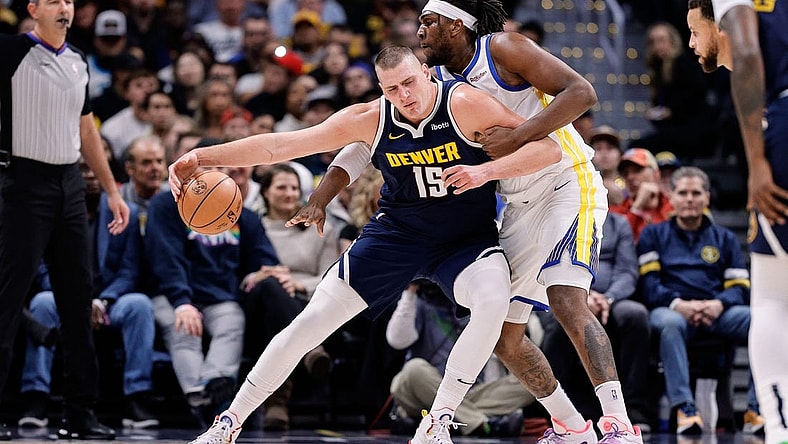 Nov 8, 2023; Denver, Colorado, USA; Denver Nuggets center Nikola Jokic (15) controls the ball under pressure from Golden State Warriors forward Kevon Looney (5) in the first quarter at Ball Arena. Mandatory Credit: Isaiah J. Downing-USA TODAY Sports