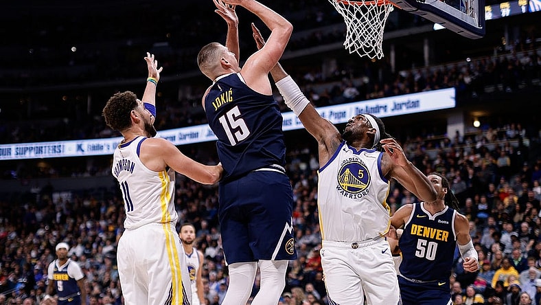 Nov 8, 2023; Denver, Colorado, USA; Denver Nuggets center Nikola Jokic (15) attempts a shot against Golden State Warriors forward Kevon Looney (5) and guard Klay Thompson (11) in the third quarter at Ball Arena. Mandatory Credit: Isaiah J. Downing-USA TODAY Sports