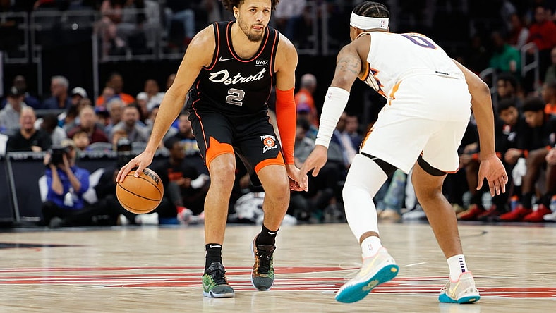 Nov 5, 2023; Detroit, Michigan, USA;  Detroit Pistons guard Cade Cunningham (2) dribbles defended by Phoenix Suns guard Jordan Goodwin (0) at Little Caesars Arena. Mandatory Credit: Rick Osentoski-USA TODAY Sports