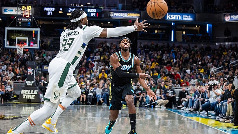 Nov 9, 2023; Indianapolis, Indiana, USA; Indiana Pacers guard Buddy Hield (7) passes the ball while Milwaukee Bucks forward Jae Crowder (99) defends in the second half at Gainbridge Fieldhouse. Mandatory Credit: Trevor Ruszkowski-USA TODAY Sports
