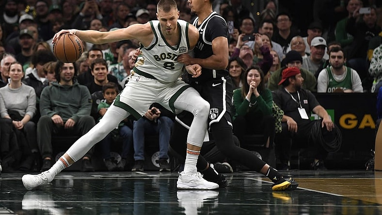 Nov 10, 2023; Boston, Massachusetts, USA;  Boston Celtics center Kristaps Porzingis (8) controls the ball while Brooklyn Nets forward Cameron Johnson (2) defends during the first half at TD Garden. Mandatory Credit: Bob DeChiara-USA TODAY Sports