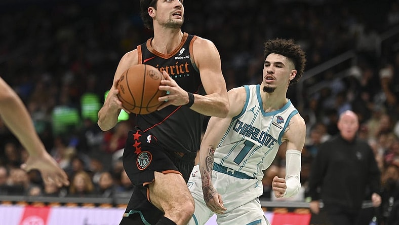 Nov 10, 2023; Washington, District of Columbia, USA;  Washington Wizards forward Deni Avdija (8) makes aa move to the basket y Charlotte Hornets guard LaMelo Ball (1) during the first half at Capital One Arena. Mandatory Credit: Tommy Gilligan-USA TODAY Sports