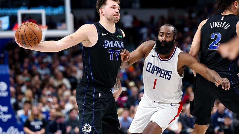 Nov 10, 2023; Dallas, Texas, USA;  Dallas Mavericks guard Luka Doncic (77) passes around LA Clippers guard James Harden (1) during the second quarter at American Airlines Center. Mandatory Credit: Kevin Jairaj-USA TODAY Sports