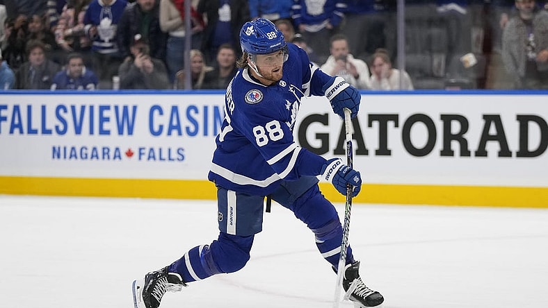 Nov 10, 2023; Toronto, Ontario, CAN; Toronto Maple Leafs forward William Nylander (88) shoots the puck against the Calgary Flames during the overtime shootout at Scotiabank Arena. Mandatory Credit: John E. Sokolowski-USA TODAY Sports