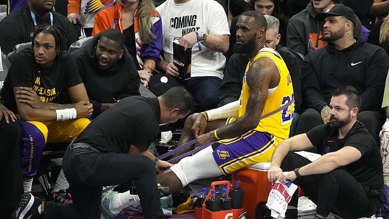 Nov 10, 2023; Phoenix, Arizona, USA; Los Angeles Lakers forward LeBron James (23) gets medical attention in a timeout against the Phoenix Suns in the first half at Footprint Center. Mandatory Credit: Rick Scuteri-USA TODAY Sports