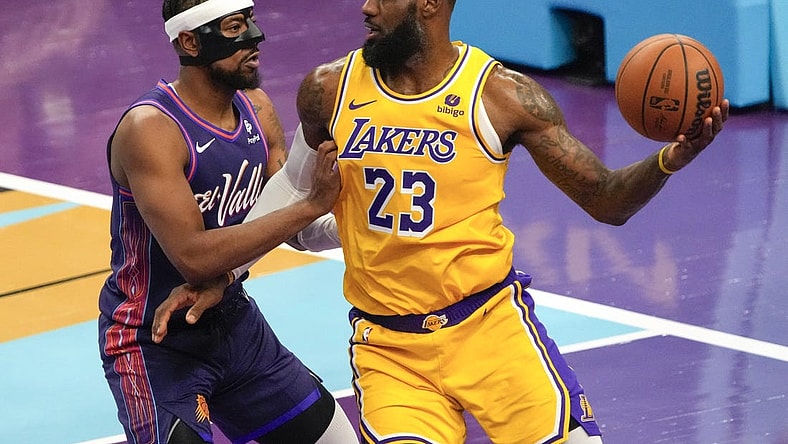 Nov 10, 2023; Phoenix, Arizona, USA; Los Angeles Lakers forward LeBron James (23) drives against Phoenix Suns guard Jordan Goodwin (0) in the first half at Footprint Center. Mandatory Credit: Rick Scuteri-USA TODAY Sports