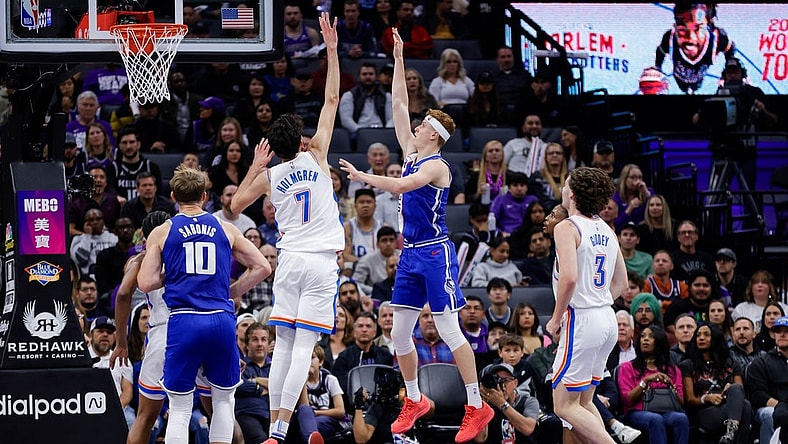 Nov 10, 2023; Sacramento, California, USA; Sacramento Kings guard Kevin Huerter (9) shoots the ball over Oklahoma City Thunder forward Chet Holmgren (7) during the second quarter at Golden 1 Center. Mandatory Credit: Sergio Estrada-USA TODAY Sports