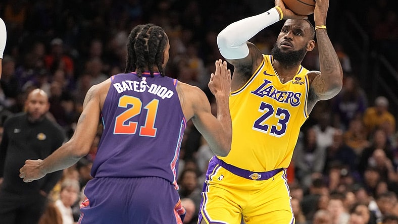 Nov 10, 2023; Phoenix, Arizona, USA; Los Angeles Lakers forward LeBron James (23) shoots against Phoenix Suns forward Keita Bates-Diop (21) in the first half at Footprint Center. Mandatory Credit: Rick Scuteri-USA TODAY Sports