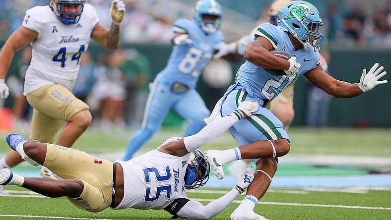 Nov 11, 2023; New Orleans, Louisiana, USA; Tulsa Golden Hurricane safety Jaise Oliver (25) tries to tackler Tulane Green Wave running back Makhi Hughes (21) in first quarter action at Yulman Stadium. Mandatory Credit: Matthew Dobbins-USA TODAY Sports