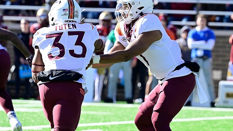 Nov 11, 2023; Chestnut Hill, Massachusetts, USA; Virginia Tech Hokies quarterback Kyron Drones (1) hands the ball to running back Bhayshul Tuten (33) during the first half against the Boston College Eagles at Alumni Stadium. Mandatory Credit: Eric Canha-USA TODAY Sports